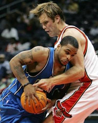 Atlanta Hawks center Jason Collier, right, is shown defending Orlando Magic's Jameer Nelson in an exhibition game Tuesday, Oct. 11, 2005 in Atlanta. Collier died early Saturday morning, Oct. 15, 2005 a team spokesman said. He was 28. Collier, a five-year NBA veteran, died of a possible cardiac arrest, said Arthu Triche, a spokesman for the team. (AP 