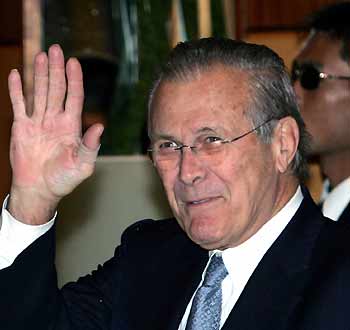 US Secretary of Defense Donald Rumsfeld waves as he walks into a hotel in Beijing October 18, 2005. [Reuters]