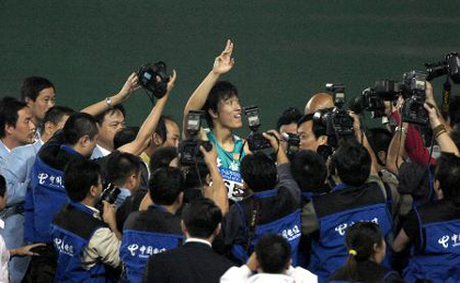 Olympic gold medallist Liu Xiang of China reacts after winning the final of the 110-meter hurdles at the 10th National Games of the People's Republic of China in Nanjing. 