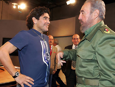 Diego Maradona (L) and Cuban President Fidel Castro smile after appearing together on a live television broadcast in Havana, October 27, 2005. Maradona was in Havana to interview Castro for his weekly television show in Argentina and promised President Castro he would be at the front of an anti-Bush march in Argentina next week.