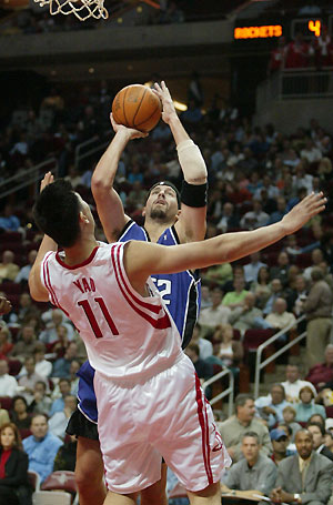 acramento Kings center Brad Miller sends Houston Rockets center Yao Ming reeling as he drives to the basket in the first half of their NBA game November 2, 2005 in Houston.