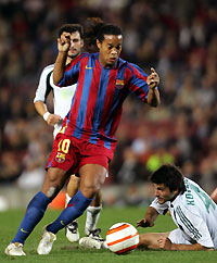 Barcelona's Ronaldinho (C) of Brazil fights for the ball against Panathinaikos' Elias Kotsios (R) and captain Ezequiel Gonzalez (L) during their Champions League Group C match at Nou Camp Stadium in Barcelona, Spain November 2, 2005. Barcelona won the match 5-0.