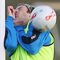 David Beckham is hit by a football during a training session at Carrington training complex in Manchester November 9, 2005. 