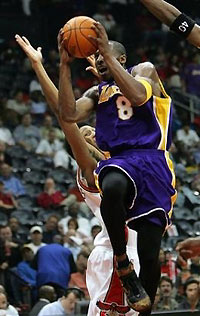 Los Angeles Lakers' Kobe Bryant drives to the basket as Atlanta Hawks' Josh Childress defends in the first quarter in Atlanta, Tuesday, Nov. 8, 2005.
