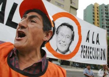 A Peruvian supporter of former Peruvian president Alberto Fujimori yells slogans in front of a banner with Fujimori's picture during a protest in front of the Chilean embassy in Lima November 10, 2005.
