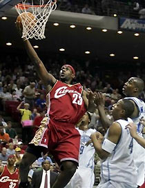 Cleveland Cavaliers' LeBron James(23) goes up for two points as Orlando Magic's DeShawn Stevenson (9), Tony Battie (4) and Dwight Howard can only watch during the first quarter in Orlando, Fla., on Sunday, Nov. 13, 2005.