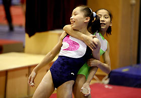 RMembers of the Chinese national gymnastics team Zhang Lin (L) and Fan Ye (R) practice at Beijing's National Gymnastics Centre November 9, 2005. China's gymnasts are training hard almost every day ahead of this month's world championships in Melbourne