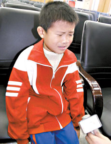 Nine-year-old He Junyao, from Xiangtan County, Hunan Province, is interviewed by local media. The boy has recovered from a bird flu infection. [Reuters]