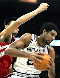 Houston Rockets Yao Ming, left, of China tries to reach for a rebound as San Antonio Spurs' Tim Duncan pulls it in, in the second quarter in the SBC Center in San Antonio, Texas, Thursday, Nov. 17, 2005.