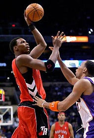 Toronto Raptors Chris Bosh shoots over Phoenix Suns' Shawn Marion during the first quarter Tuesday, Nov. 22, 2005 at America West Arena in Phoenix. 