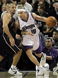 Sacramento Kings guard Mike Bibby, right, tries to drive past New Jersey Nets guard Jason Kidd during the first quarter in Sacramento, Calif., Wednesday, Nov. 23, 2005.(