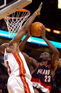 Portland Trail Blazers' Darius Miles (23) is fouled by Miami Heat's Alonzo Mourning (33) on a first-half shot Wednesday, Nov. 23, 2005, in Miami. 