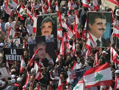 Lebanese opposition protesters carry portraits of slain former Lebanese Prime Minister Rafik Hariri during a demonstration in Beirut Martyrs square, Lebanon, in this March 14, 2005, file photo.