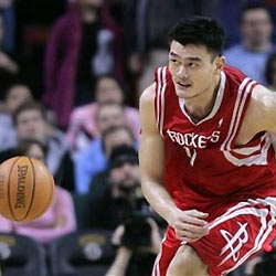 Houston Rockets' Yao Ming, of China, looks to another player as he chases a loose ball during the fourth quarter against the Seattle SuperSonics in an NBA basketball game Thursday, Dec. 15, 2005, in Seattle.