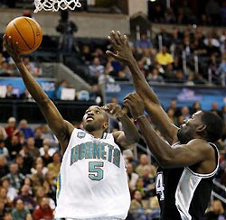New Orleans Hornets guard Speedy Claxton (5) shoots while defended by San Antonio Spurs guard Michael Finley (4) during the second half of an NBA basketball game Sunday, Dec. 18, 2005, in Oklahoma City, Okla.