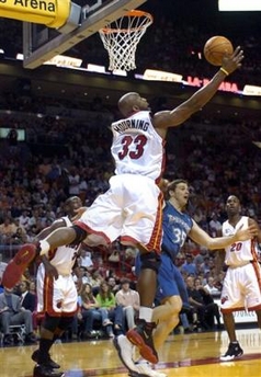 Miami Heat Alonzo Mourning (33) catches a rebound in front of Minnesota Timerwolves Mark Madsen (35) during the second quarter of an NBA basketball game, Sunday, Jan. 1, 2006, in Miami. 