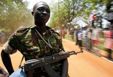 A Sudan People's Liberation Movement (SPLM) soldier keeps watch from the back of a car in Juba, southern Sudan, August 6, 2005.