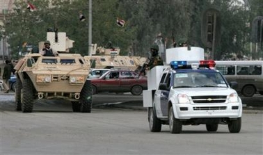 An Iraqi special police units secure the main entrance of the Ministry of Interior complex, Monday, Jan. 9, 2006, in Baghdad, Iraq. 