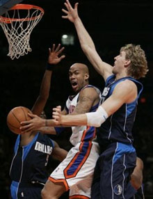 New York Knicks Stephon Marbury, center, looks to pass as Dallas Mavericks Dirk Nowitzki and Josh Howard defend in the first quarter, Wednesday, Jan. 11, 2006