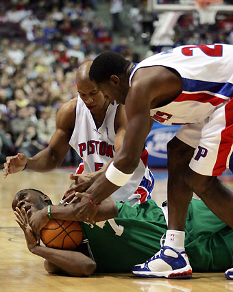 Boston Celtics forward Al Jefferson (bottom) signals for a time-out as Detroit Pistons guard Maurice Evans (C) and forward Antonio McDyess reach for the loose ball during the first half of their NBA game in Auburn Hills, Michigan January 16, 2006