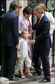 British Prime Minister Tony Blair's son Leo (C) along with brothers Nicky (L), Euan (2nd L), mother Cherie (T), sister Kathryn (R) and father Tony Blair, at the front of No. 10 Dowing Street in London, May 2005. 