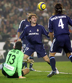Real Madrid's Antonio Cassano of Italy (C) looks at the ball next to Real Betis' Antonio Doblas (L) and Sergio Ramos before scoring during their Spanish King's cup soccer match quarter-final first leg at the Manuel Ruiz de Lopera stadium in Seville January 18, 2006. 