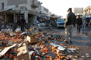 Locals pick through the damage from two bomb attacks, Thursday, Jan. 19, 2006, in Baghdad, Iraq.