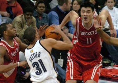Houston Rockets' Yao Ming vies for a loose ball with the Memphis Grizzlies Shane Battier (31) and the Rockets' Tracy McGrady, left, in the third quarter of NBA basketball action on Monday, Jan. 30 2006 in Memphis, Tenn.