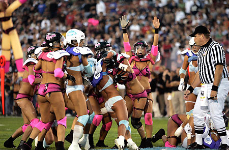 Los Angeles Temptation(blue) play against New York Euphoria during the third annual Lingerie Bowl football game in Los Angeles February 5, 2006. The 30-minute game features models playing full-contact football in lingerie and airs locally on pay-per-view during half time of the NFL's Super Bowl XL football game. [Reuters]