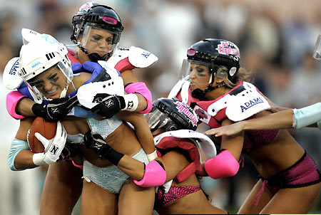 Los Angeles Temptation(blue) play against New York Euphoria during the third annual Lingerie Bowl football game in Los Angeles February 5, 2006. The 30-minute game features models playing full-contact football in lingerie and airs locally on pay-per-view during half time of the NFL's Super Bowl XL football game. [Reuters]