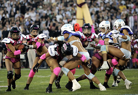 Los Angeles Temptation(blue) play against New York Euphoria during the third annual Lingerie Bowl football game in Los Angeles February 5, 2006. The 30-minute game features models playing full-contact football in lingerie and airs locally on pay-per-view during half time of the NFL's Super Bowl XL football game. [Reuters]