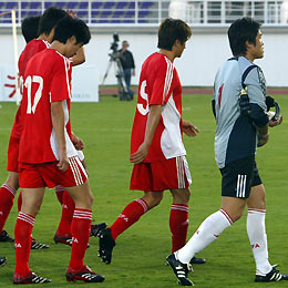 China's soccer team players leave the pitch after their loss against Iraq at the Asian Cup 2007 qualifying match at the Khalifa Bin Zayed stadium in Al Ain, United Arab Emirates March 1, 2006. 