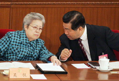 Chairman of the Chinese People's Political Consultative Conference (CPPCC) Jia Qinglin (R) talks to Chinese Vice-Premier Wu Yi during the plenary session of CPPCC at the Great Hall of the People in Beijing March 8, 2006. 