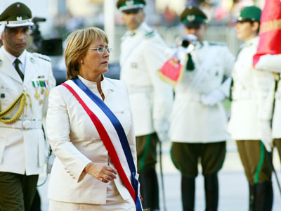 Chile's new President Michelle Bachelet reviews an honour guard as she arrives at La Moneda presidential palace after being sworn in office in Santiago March, 11, 2006. Bachelet, Chile's first female president, was sworn in on Saturday before a who's who of Latin America's resurgent leftist leadership and U.S. Secretary of State Condoleezza Rice.