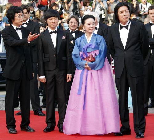 Cast members pose on red carpet for screening of film Poetry