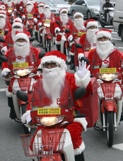 Postmen ride delivery motorcycles to deliver Christmas gifts