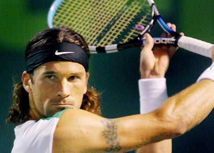 Carlos Moya of Spain sets up for a shot during his match against Agustin Calleri of Argentina at Nasdaq-100 Open tennis tournament in Key Biscayne, Florida, March 26, 2006.