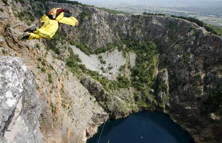 Russian base jumper Youri Kuznytzov jumps from a 250 meters (820 feet) high cliff to land in the Red Lake, near Croatia's southern town of Imotski May 24, 2007. Kuznytzov was one of six international base jumpers who jumped into the Red Lake without a permit from Croatian authorities.