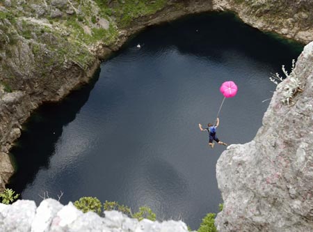 Base jumper Nenad Pesut, of Croatia, jumps from a 250 metre (820 feet) high cliff, near the southern town of Imotski, May 24, 2007. Pesut was one of 6 international base jumpers who jumped into Red Lake without a permit from Croatian authorities. 