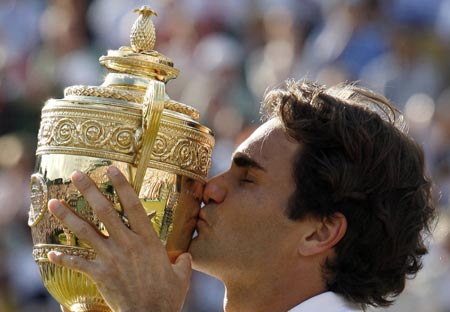 Switzerland's Roger Federer kisses the trophy after winning his men's final match against Spain's Raphael Nadal at the Wimbledon tennis championships in London, July 8, 2007.