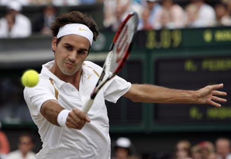 Switzerland's Roger Federer returns the ball to Spain's Rafael Nadal during the men's singles final at the Wimbledon tennis championships in London, July 8, 2007.