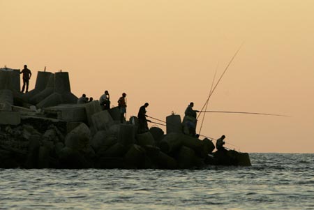 Palestinians fish from the Gaza sea July 10, 2007. 