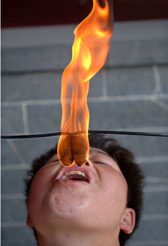 Fire-swallowing man