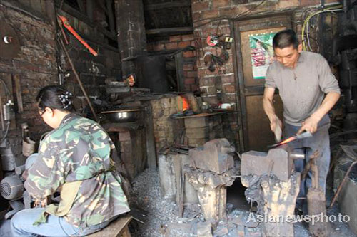 Husband-wife team work together as blacksmiths