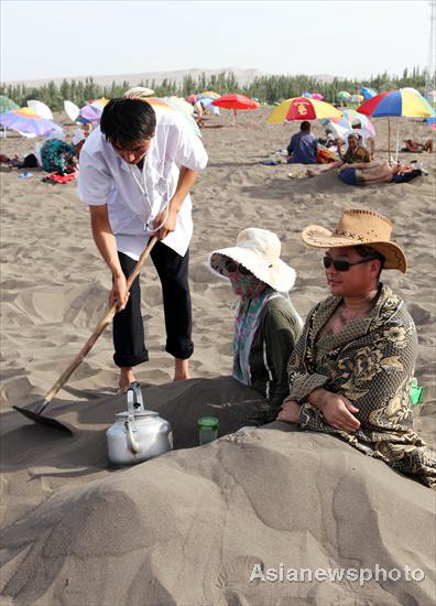 Hot sand treatment lures tourists to Xinjiang