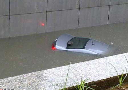 In a flash, car sinks in rainwater