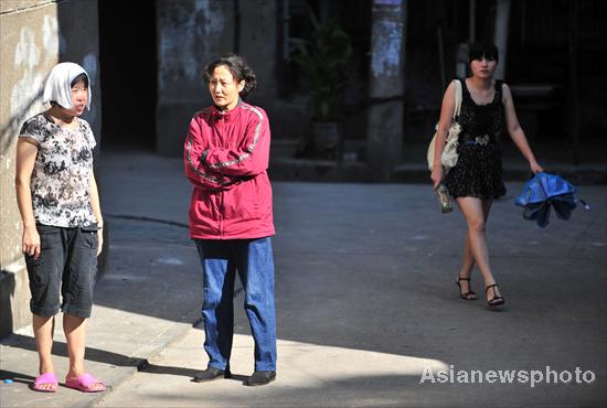 Woman trembles with cold under scorching sun