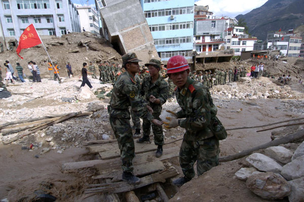 Frantic search for signs of life after landslide