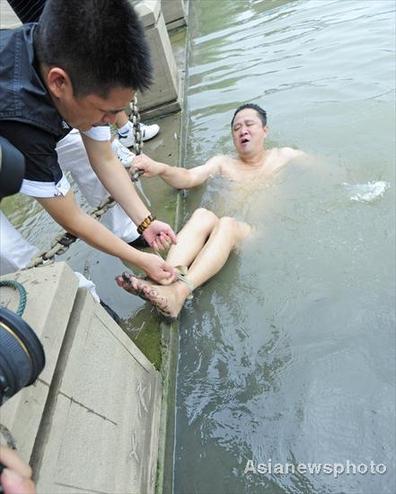 Swimmer jumps into river all tied up