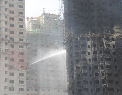 Unfinished high rise catches fire in NE China